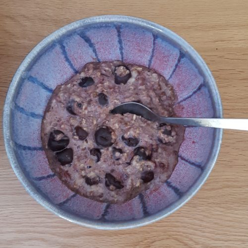 Healthy breakfast porridge with cherries in a bowl